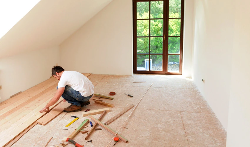Man installing flooring in a home