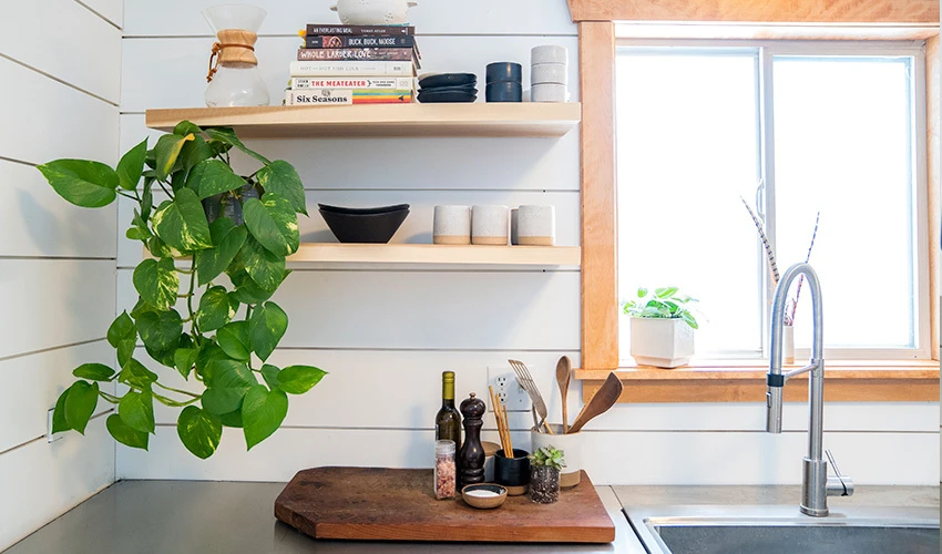 Farmhouse kitchen with greenery and shiplap walls.