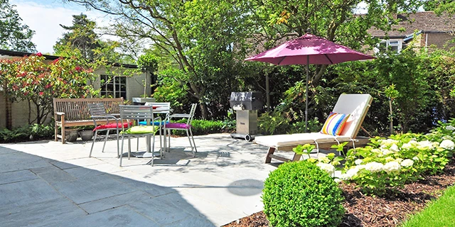 nice uncovered stone porch with sitting area