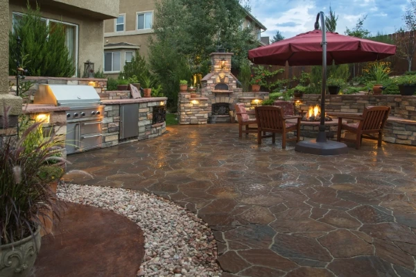 well landscaped back deck with stone flooring