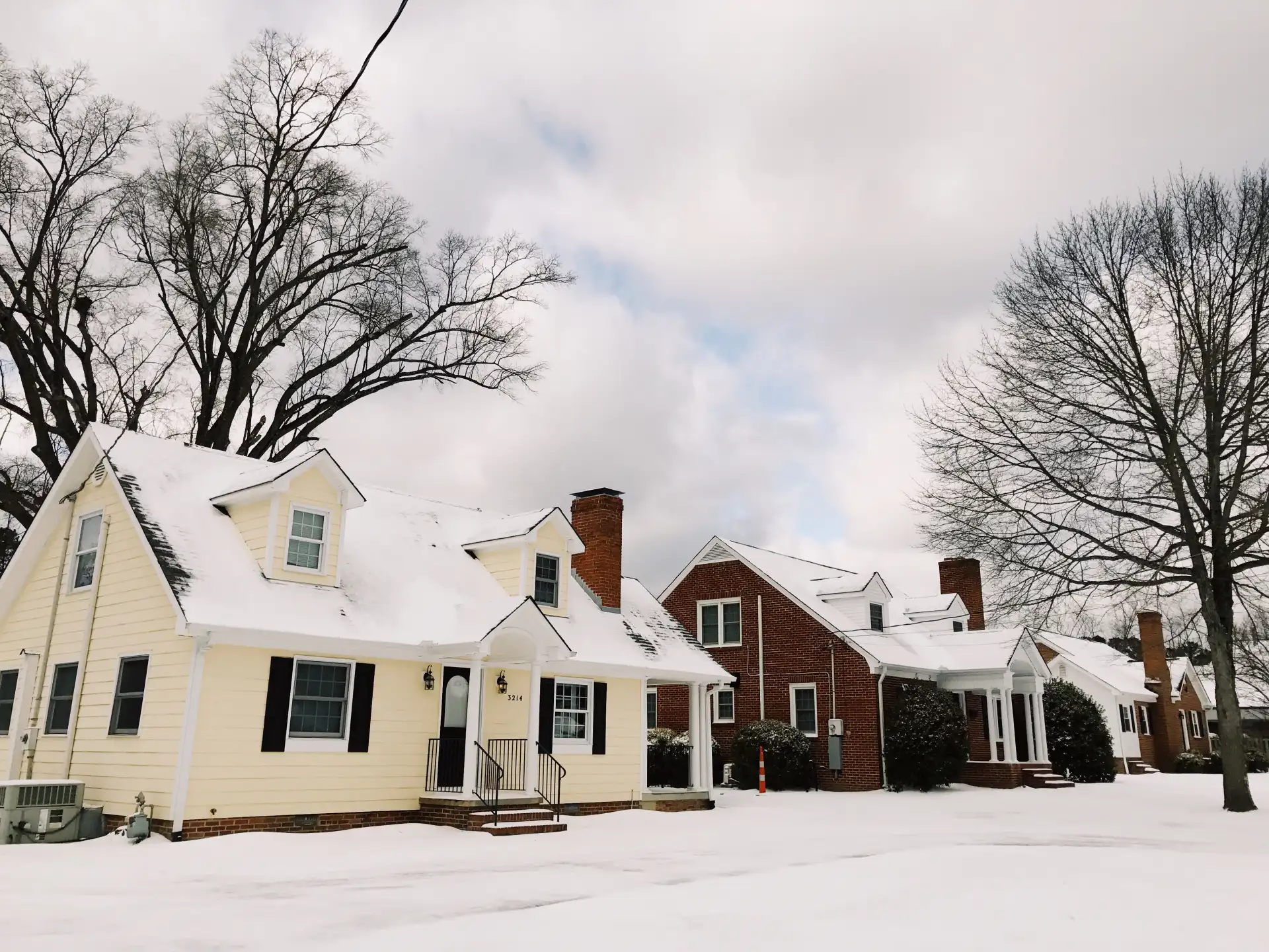 two homes side by side in a winter landscape