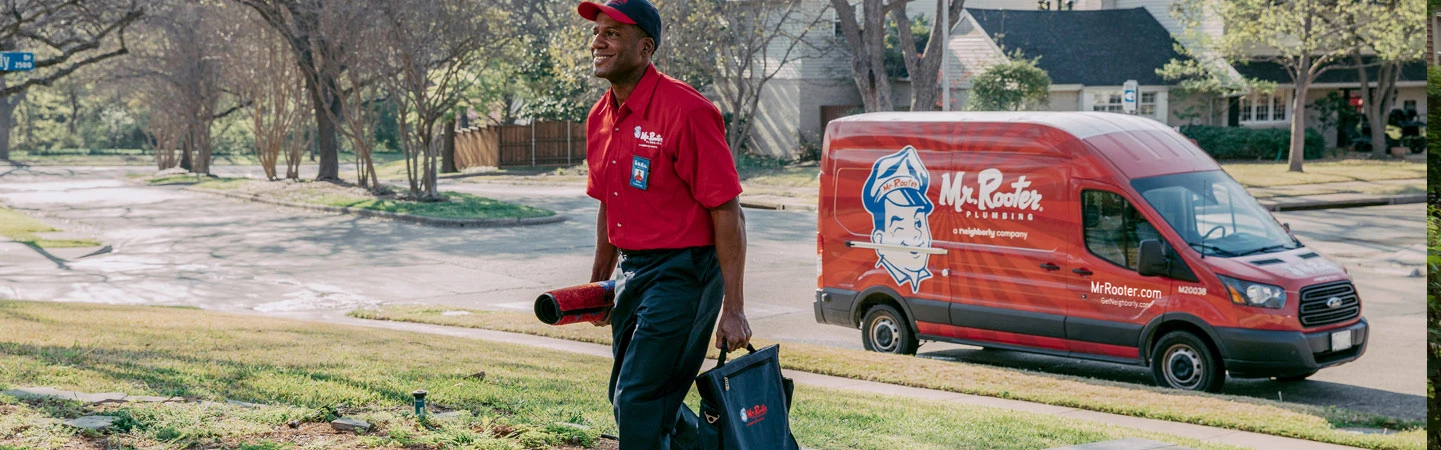 Mr. Rooter employee walking to meet a client