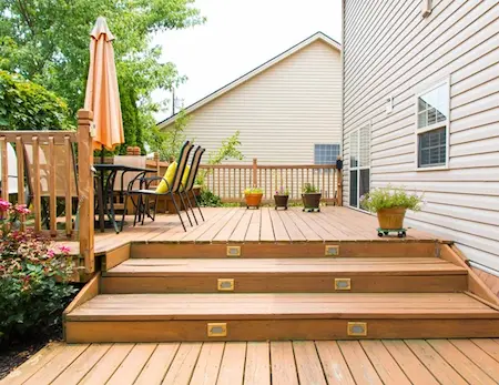 Wooden patio deck decorated with flowers.