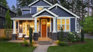 Front of large, well landscaped home.