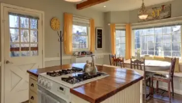 Breakfast nook with table, chairs, and bench seating in kitchen of a residential home.