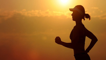 Silhouette of a woman running at sunset