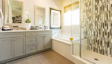 Modern master bathroom with tiled shower.