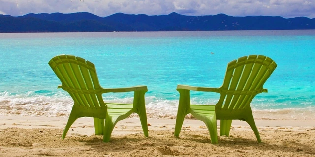 Beach chairs facing the water.