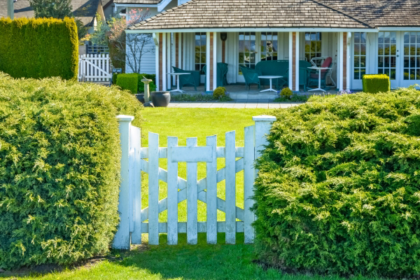 beautifull landscaped home with a front yard patio.