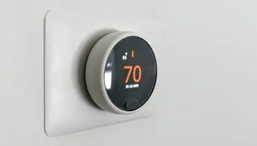 Digital thermostat showing 70 degrees.