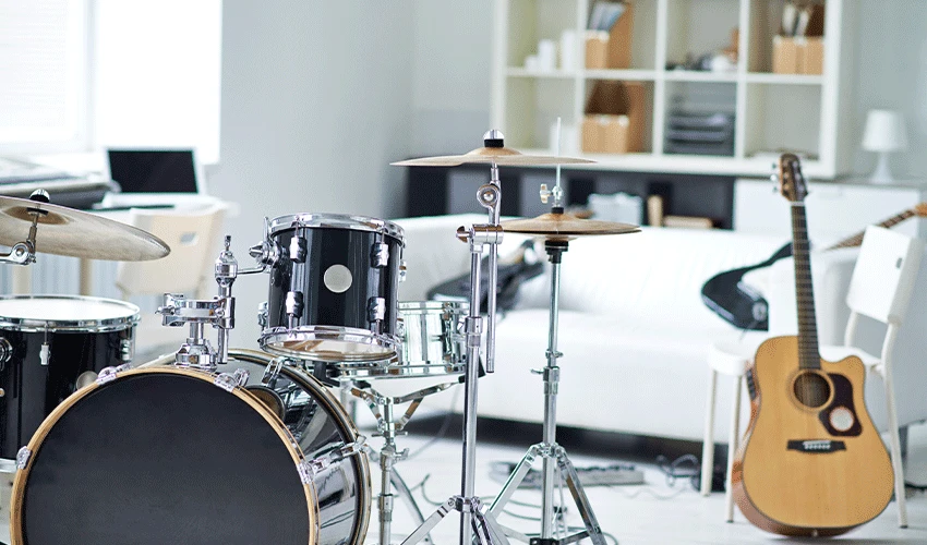 Drum kit and guitar in music room