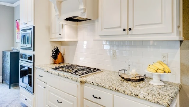 White kitchen wall cabinets and backsplash.
