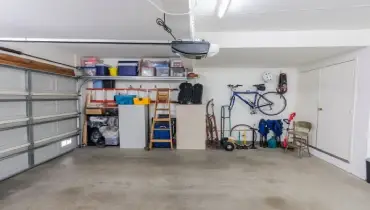 Organized clean suburban residential two car garage with tools, file cabinets and sports equipment.