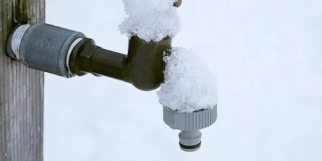 snow-covered outdoor faucet.