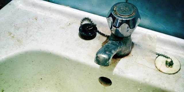 dirty bathroom sink and faucet.