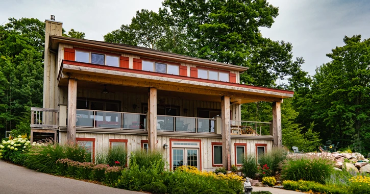 Home with wood siding and red shutters.