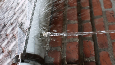 Rain falling into gutters.