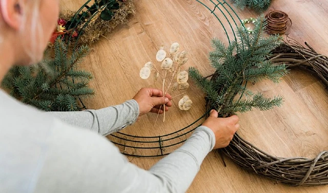 Person creating a wreath.