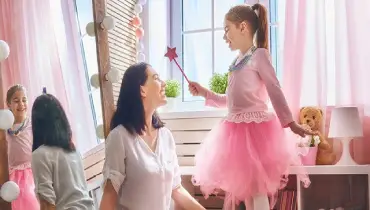 Mom and daughter playing princess game at home