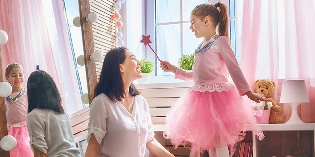Mom and daughter playing princess game at home