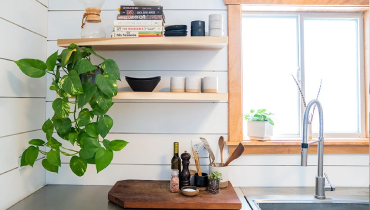 Farmhouse kitchen with greenery and shiplap walls.