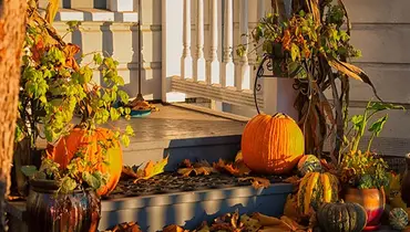 Front porch decorated for fall.