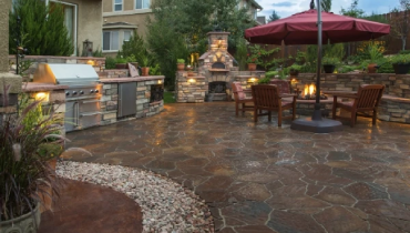 Well landscaped back deck with stone flooring.